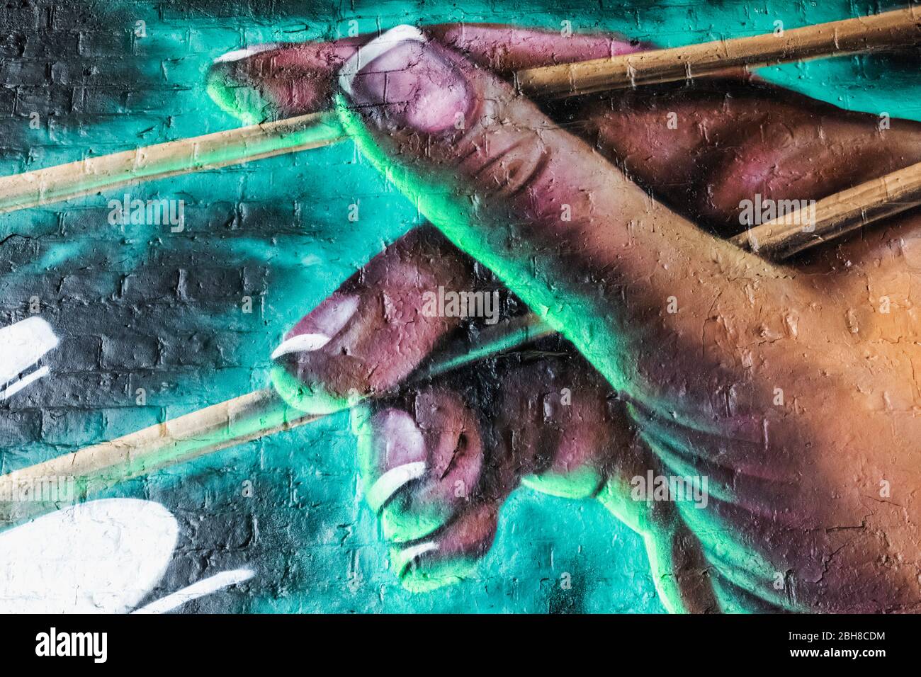 England, London, Southwark, Street Art depicting Hand Holding Chopsticks Stock Photo