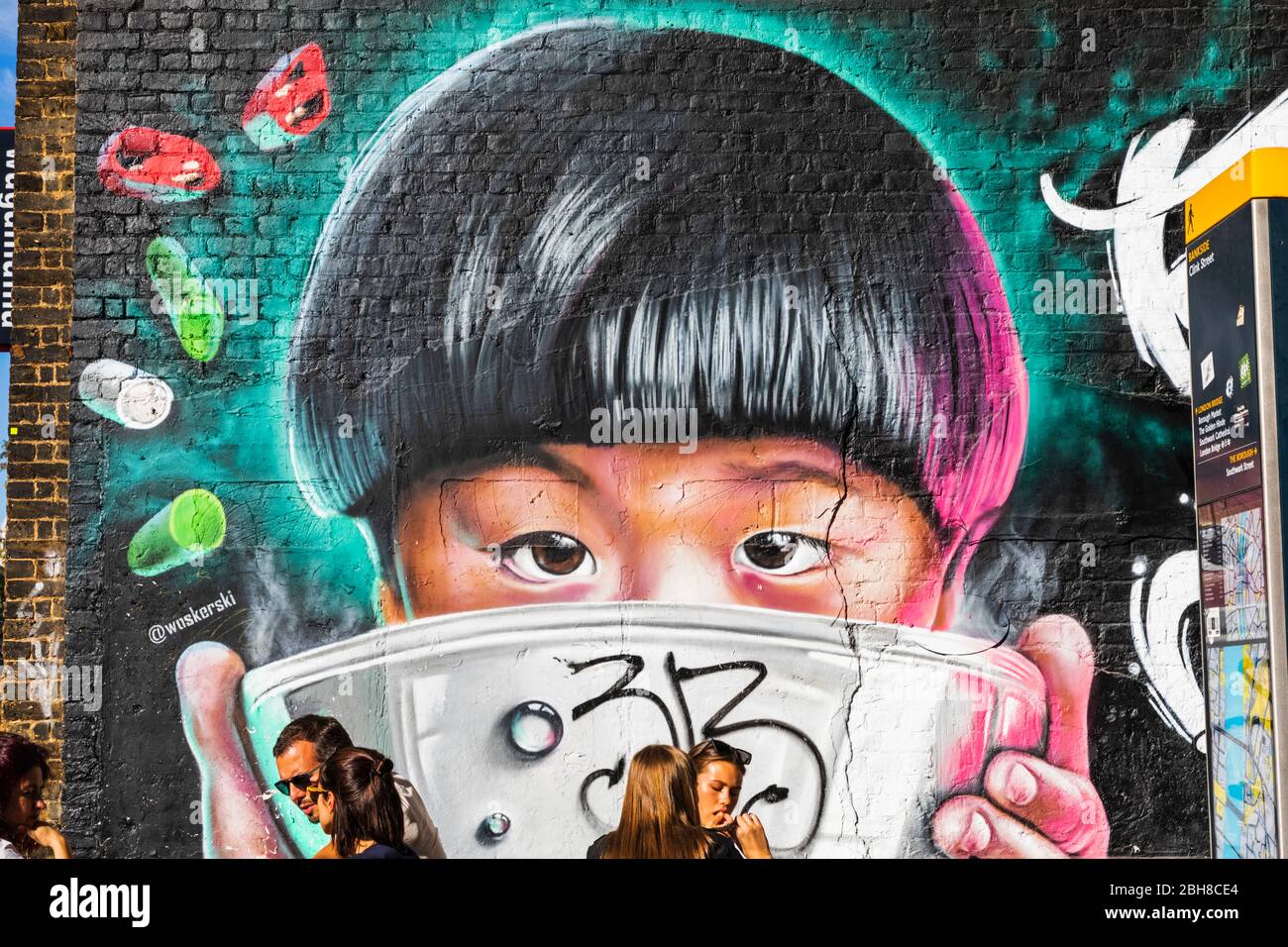 England, London, Southwark, London Bridge City, Borough Market, Wall Art of Asian Child with Rice Bowl and Restaurant Customers Eating Asian Food Stock Photo