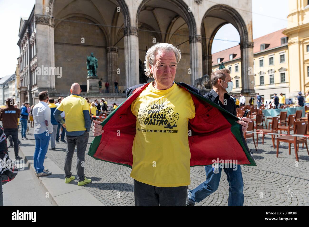 Munich. 24th Apr, 2020. Munich 24. April 2020 | An employee of the renowned restaurant 'Blauer Bock' at a rally to support the gastronomy. The catering trade is particularly hard hit by the restrictions on going out and the ban on contact. Credit: Thomas Vonier/ZUMA Wire/Alamy Live News Stock Photo