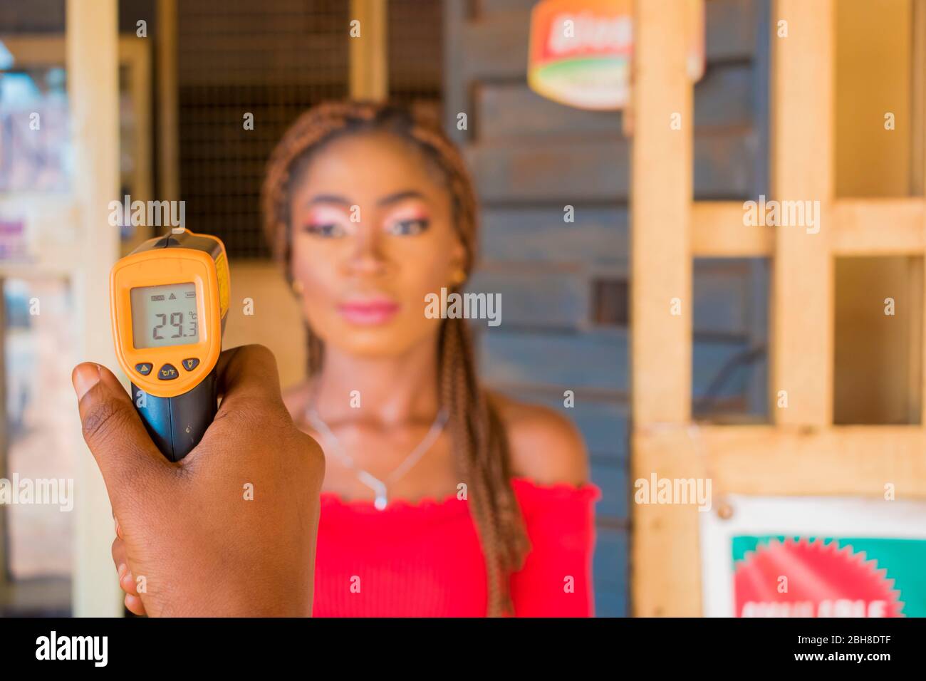 Close-up shot of a young african woman using infrared forehead ...