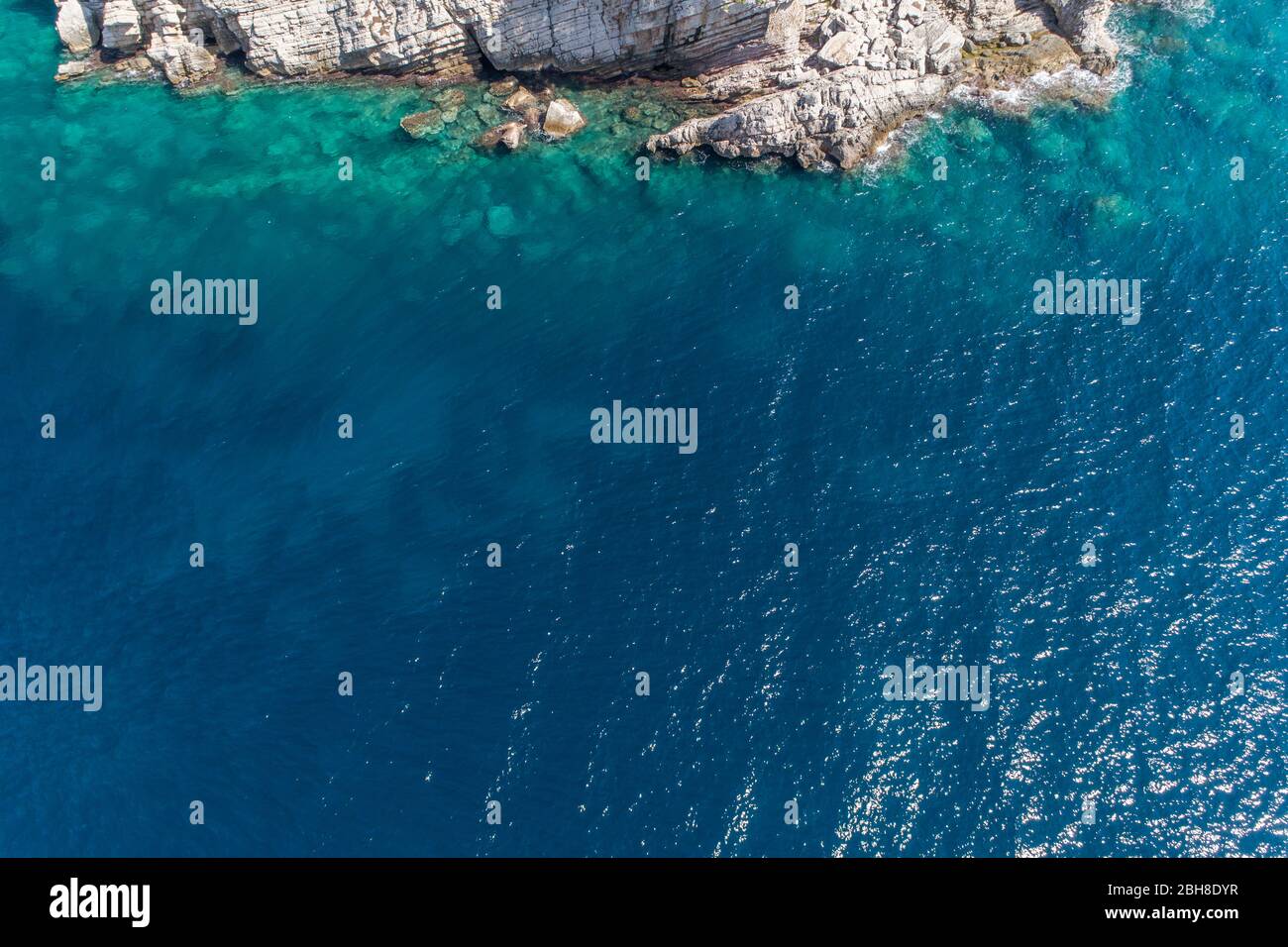 Aerial view of the rocky bottom of the Adriatic Sea covered with turquoise water Stock Photo