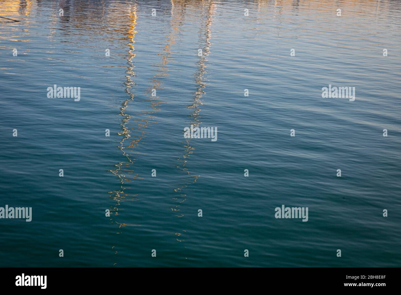 Reflections of boats in the harbor on sea water Stock Photo - Alamy