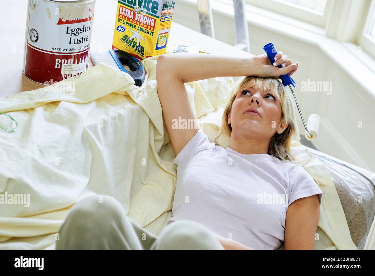 Woman laid resting whilst decorating Stock Photo