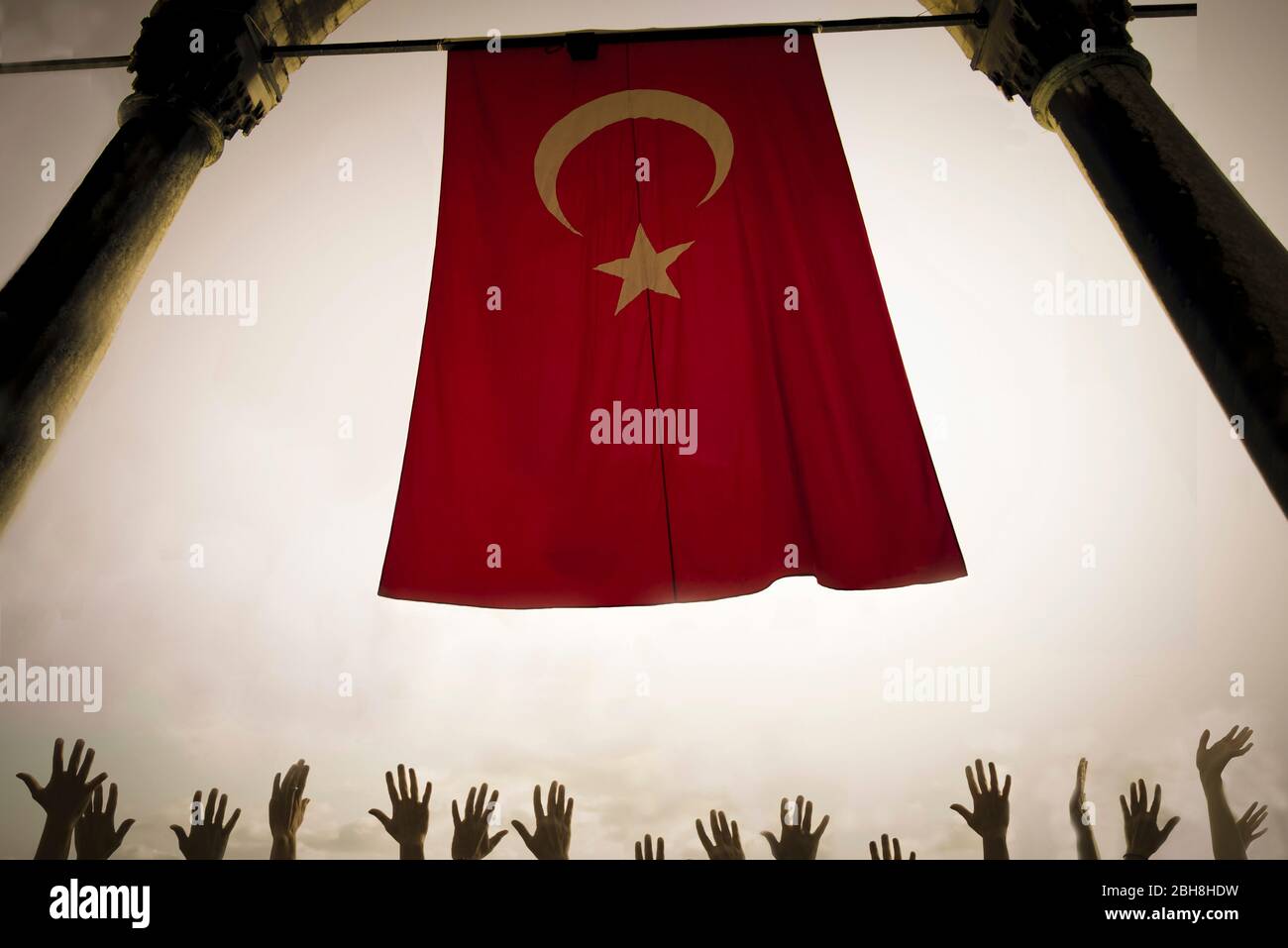Politics and religion concept with red flag against the sky and lot of hands like prayer or crown concept - muslim and christian culture with war and love Stock Photo