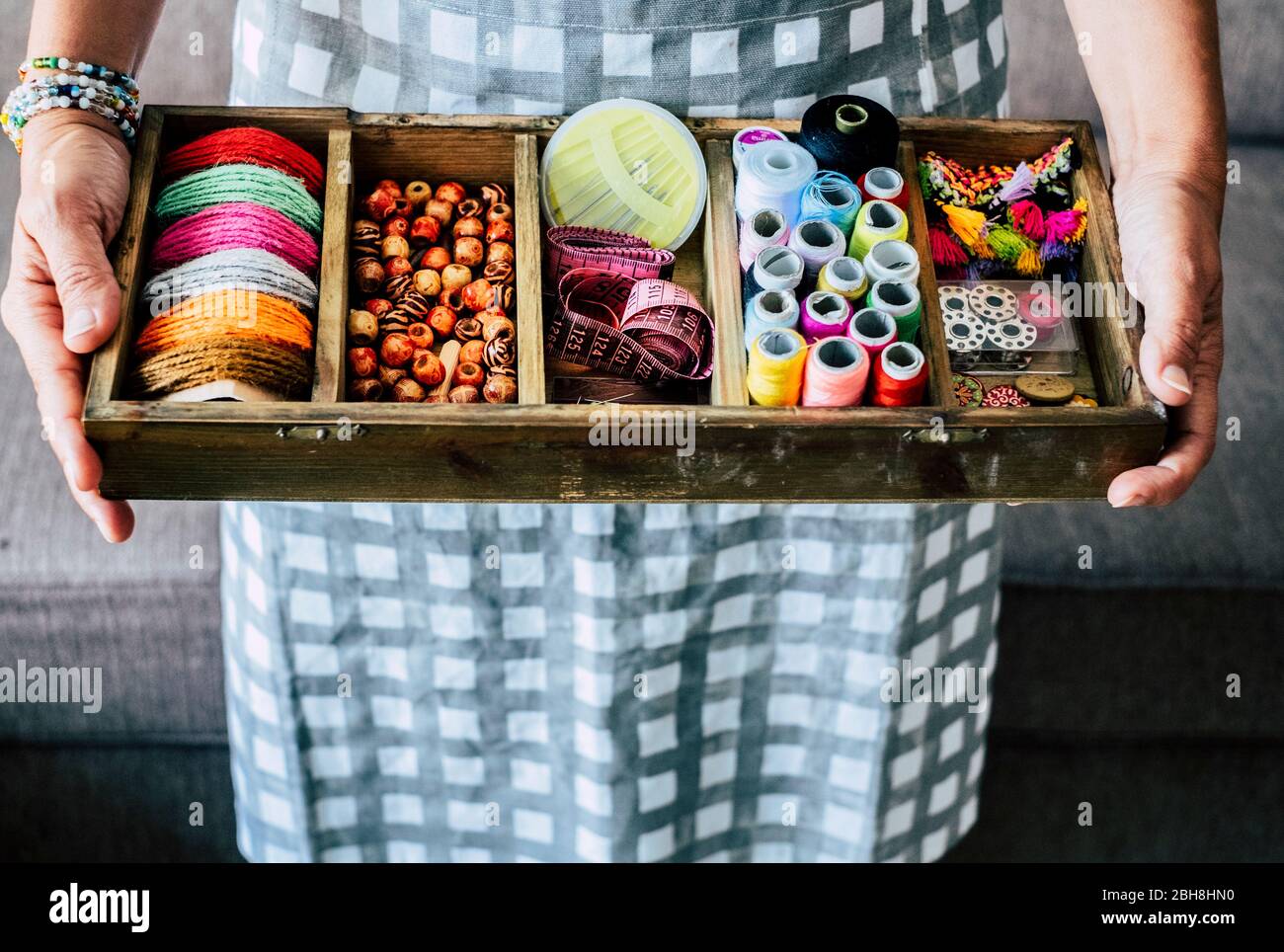 Above view of woman taking and showing fabrics buttons and accessories