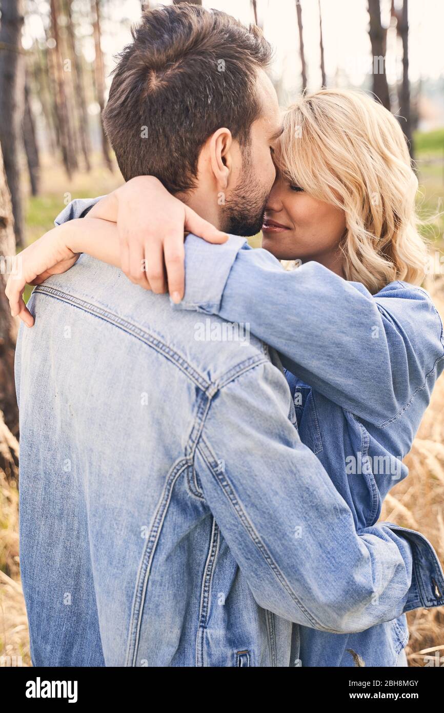 Woman with her eyes closed hugging her boyfriend Stock Photo - Alamy
