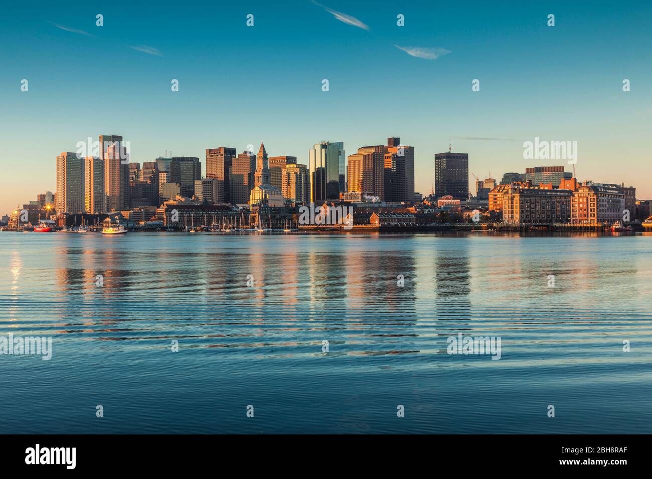 USA, New England, Massachusetts, Boston, city skyline from Boston Harbor, dawn Stock Photo