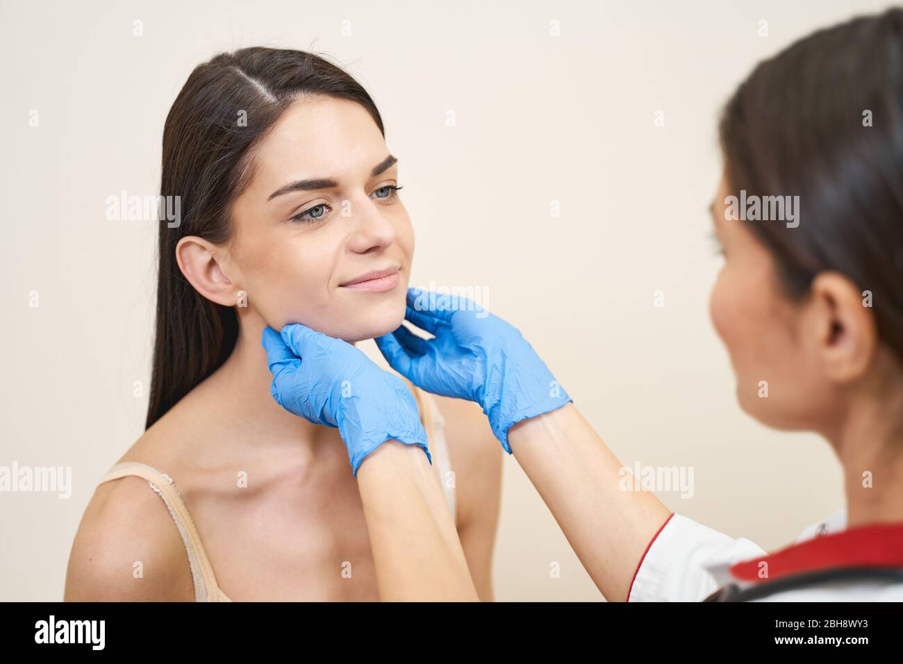 Positive delighted females looking at each other Stock Photo - Alamy