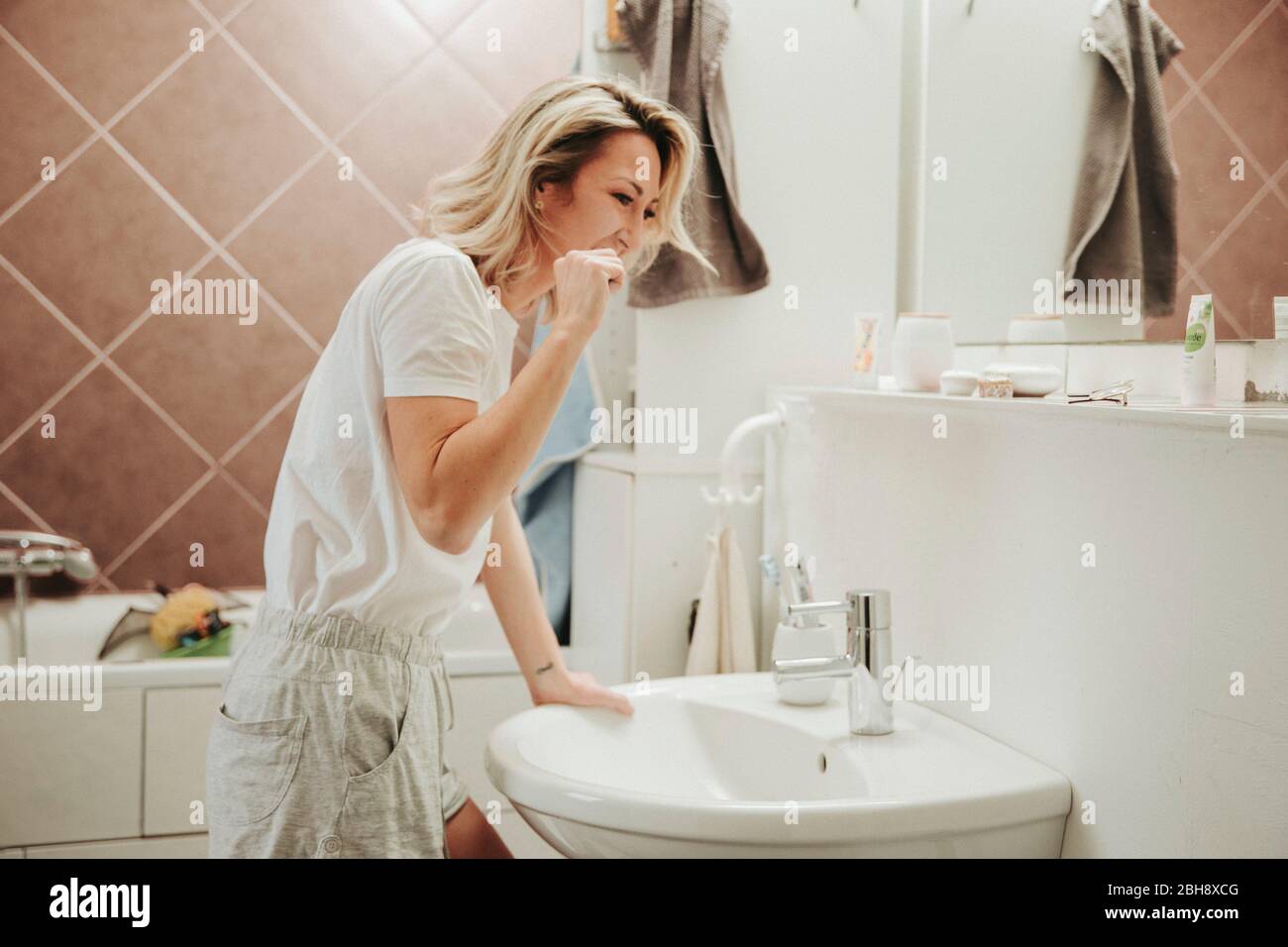 Frau beim Zähne putzen im Bad Stock Photo