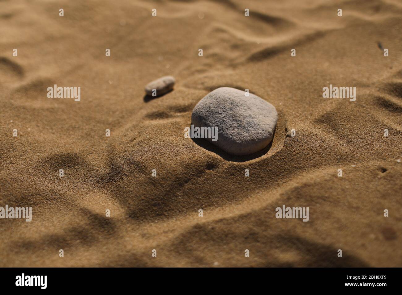 stones on the sand beach background. natural wallpaper, texture. selective focus. cope space. Stock Photo