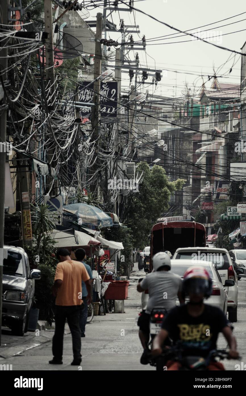 City scenery with traffic and immense numbers of power and telephone lines Stock Photo