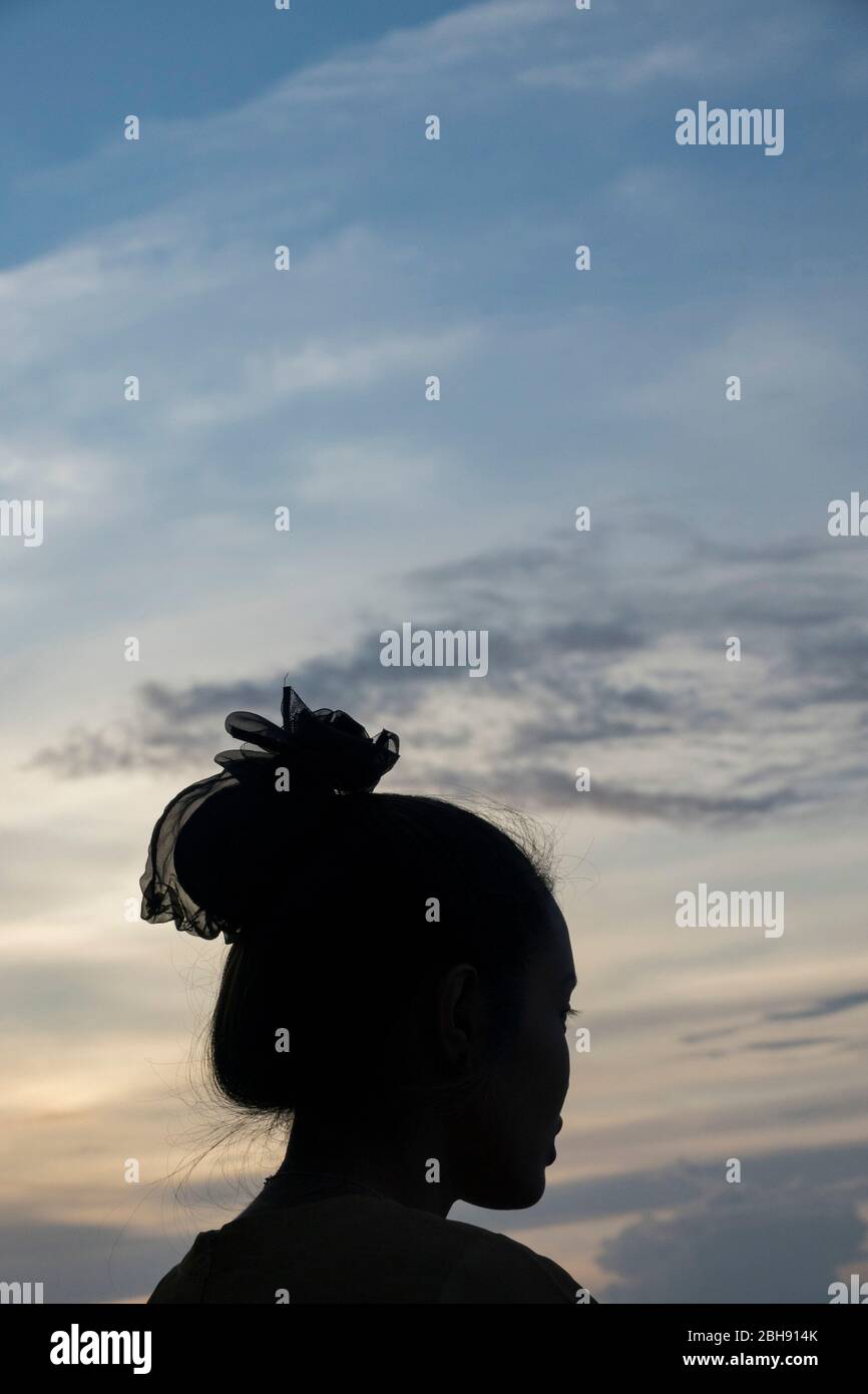 Young Thai woman in silhouette outdoors Stock Photo