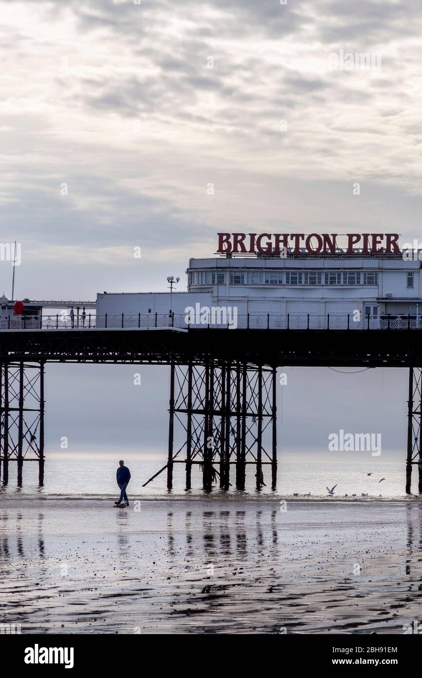 man alone at Brighton pier Stock Photo