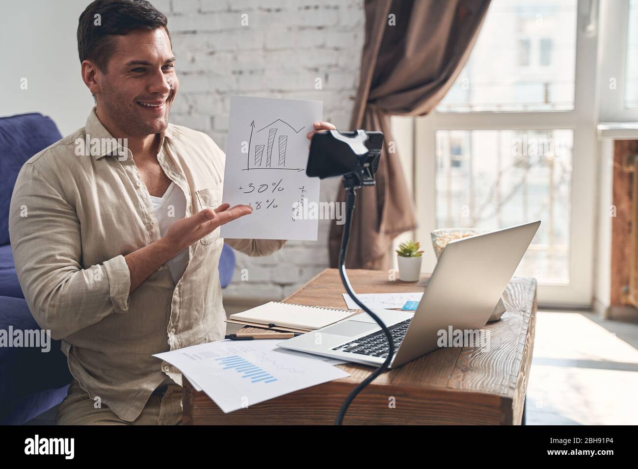 Blogger sitting in front of the cellphone camera Stock Photo