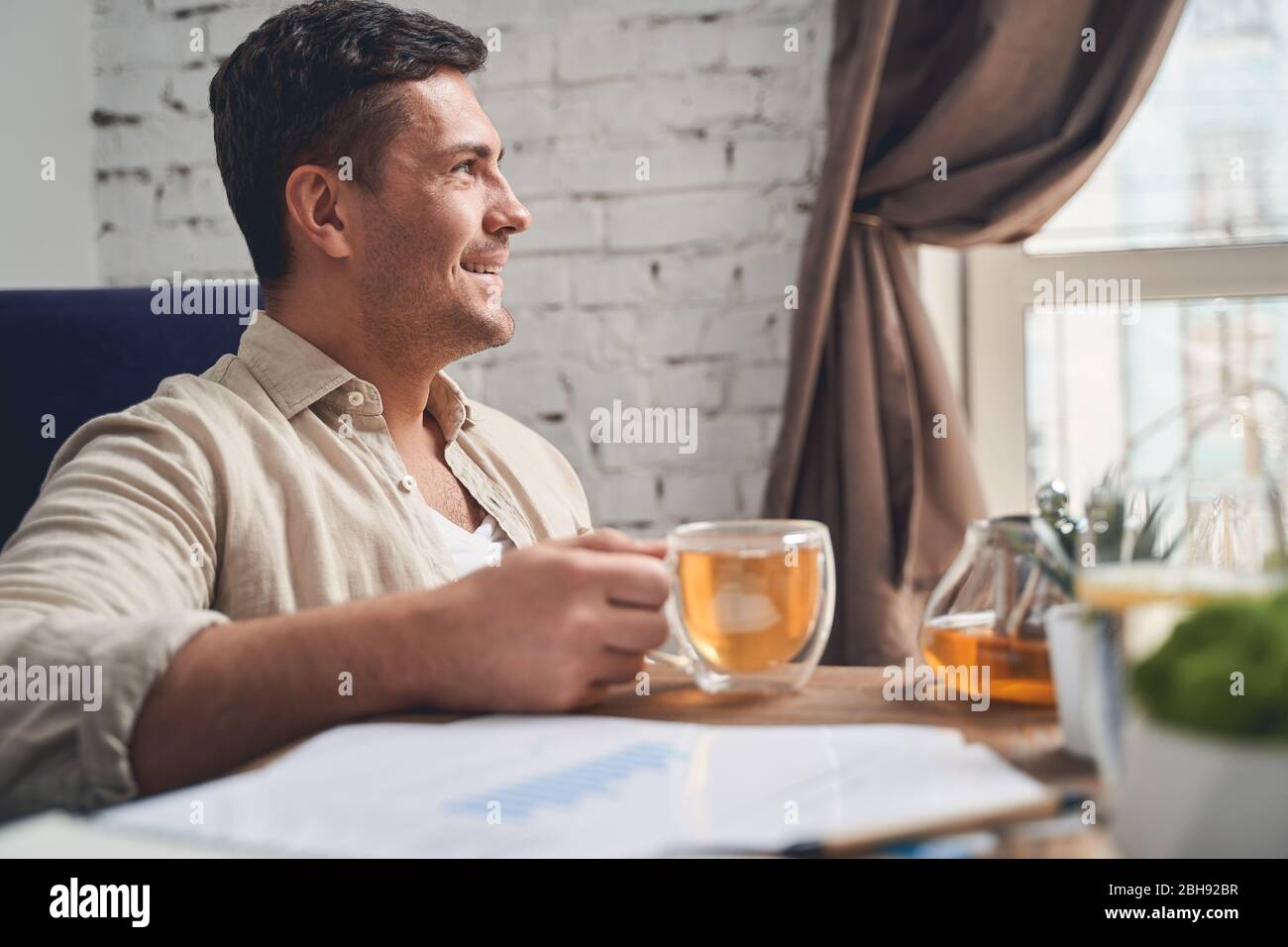 Joyous telecommuter taking a break from work Stock Photo