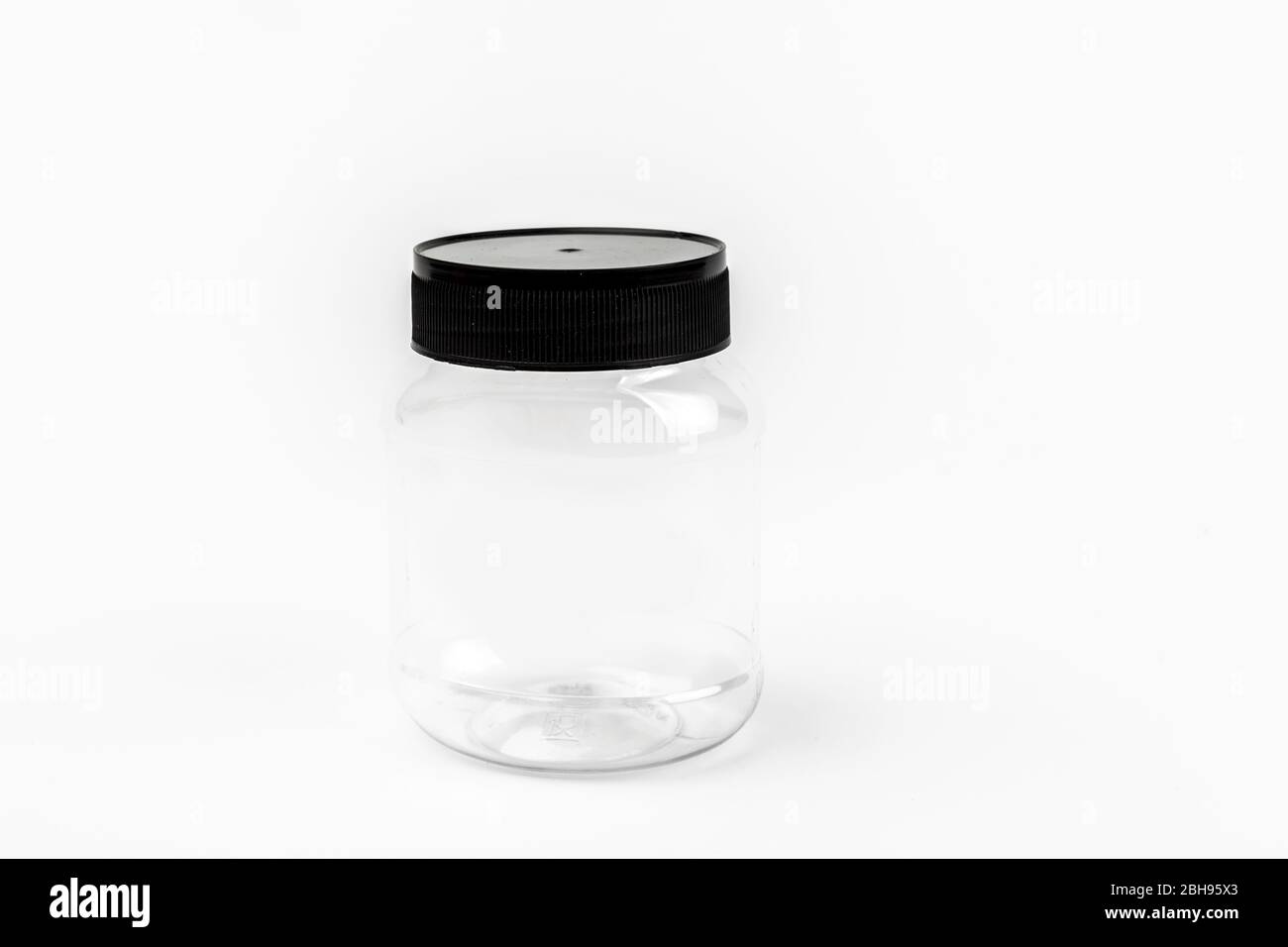 empty transparent plastic jar on white background Stock Photo