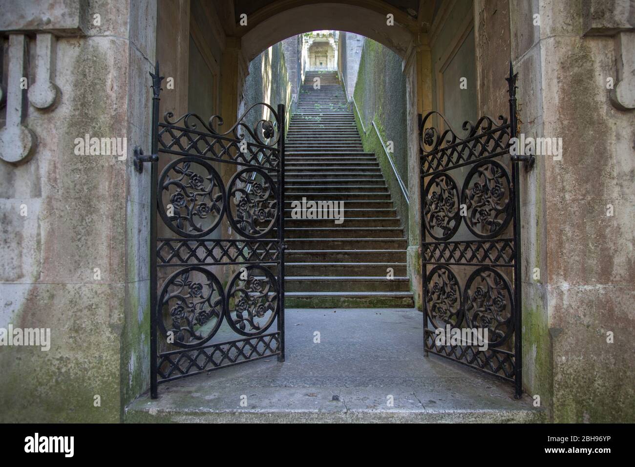 open gate in front of stairs, cemetery Cimitero di Staglieno, Genoa, Italy Stock Photo