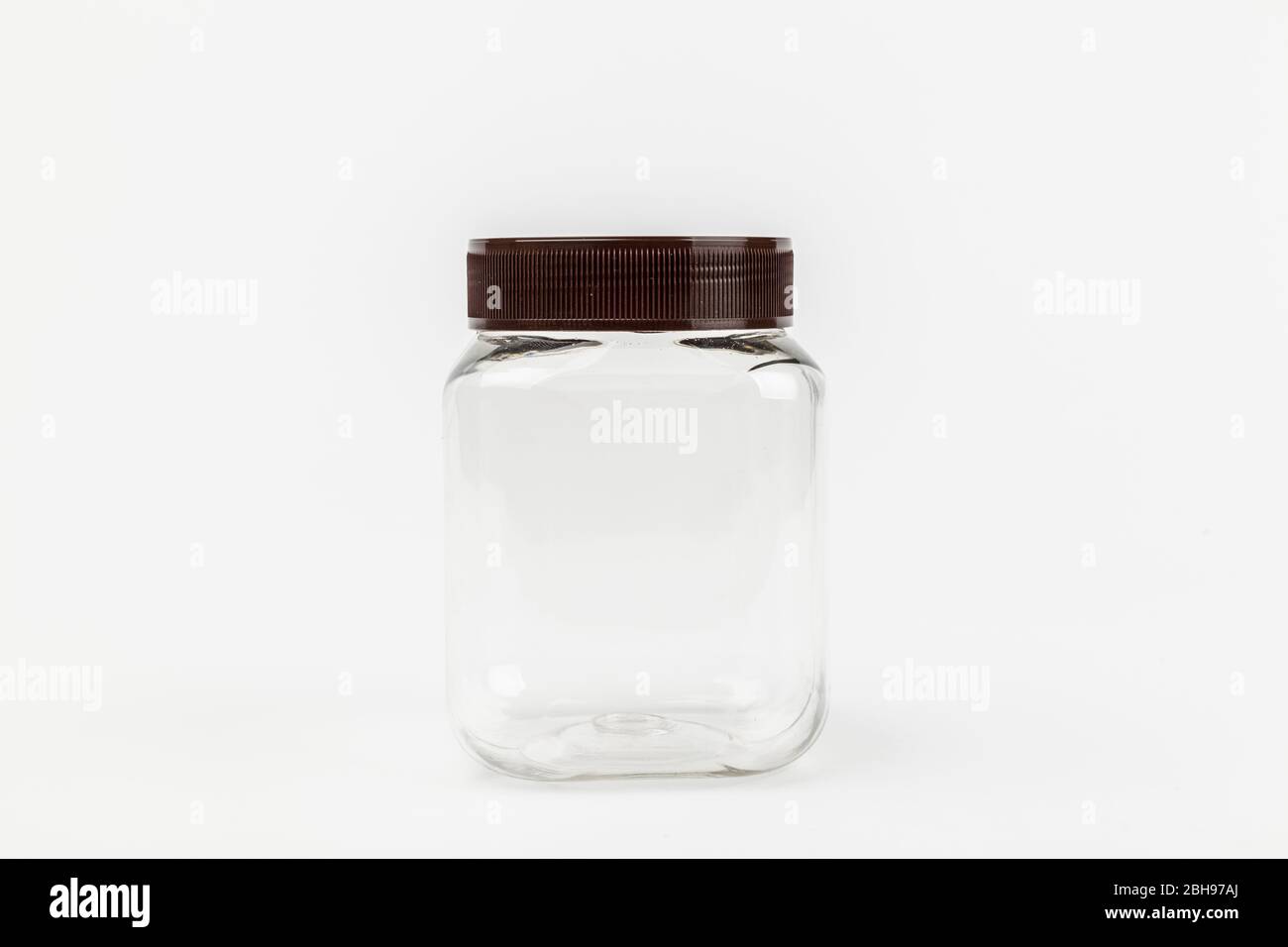 empty transparent plastic jar on white background Stock Photo