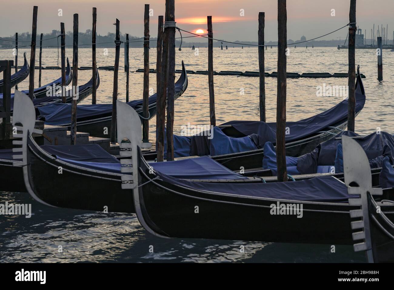 Venice at sunrise in winter, view from St Mark's Square with gondolas in the foreground to the Grand Canal Stock Photo