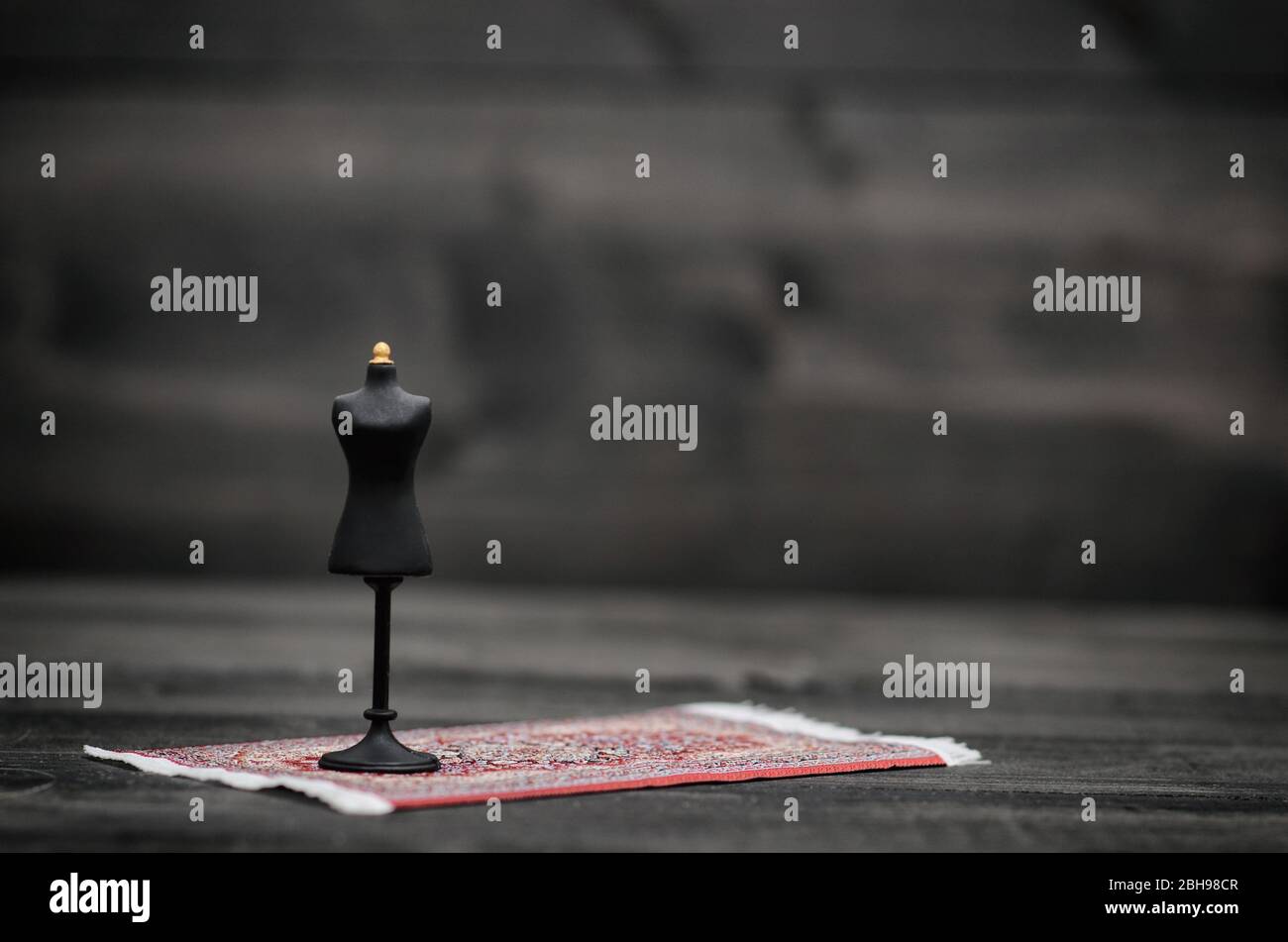 Fashion design concept, vintage mannequin stand on black wooden