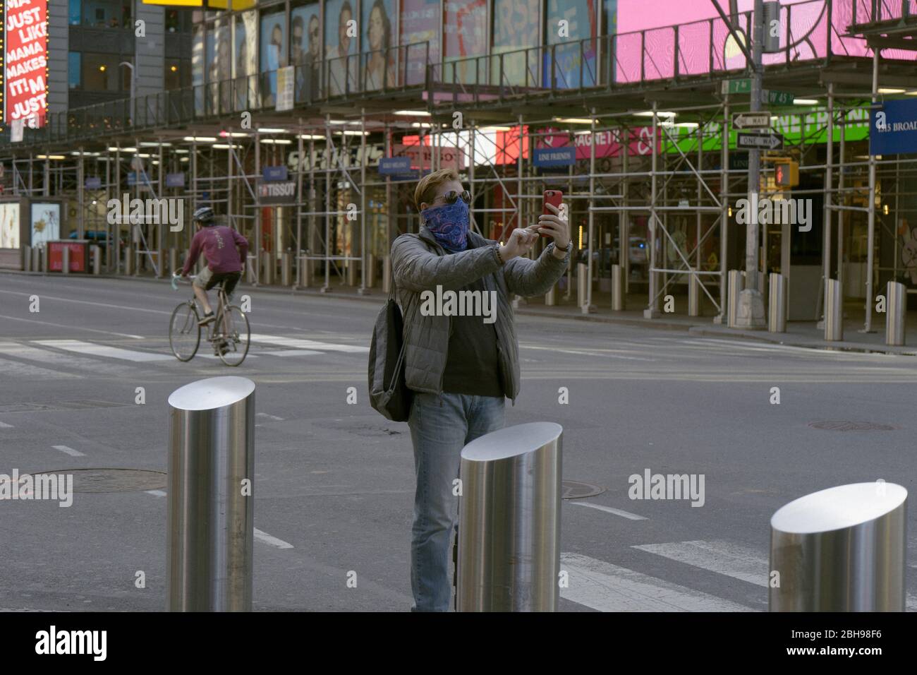 Middle aged man taking a selfie on a deserted street in Times Square Stock Photo