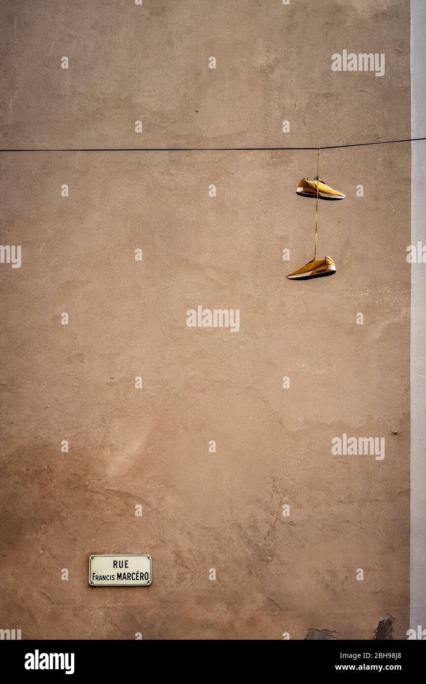 Hanging sneakers in Narbonne Stock Photo
