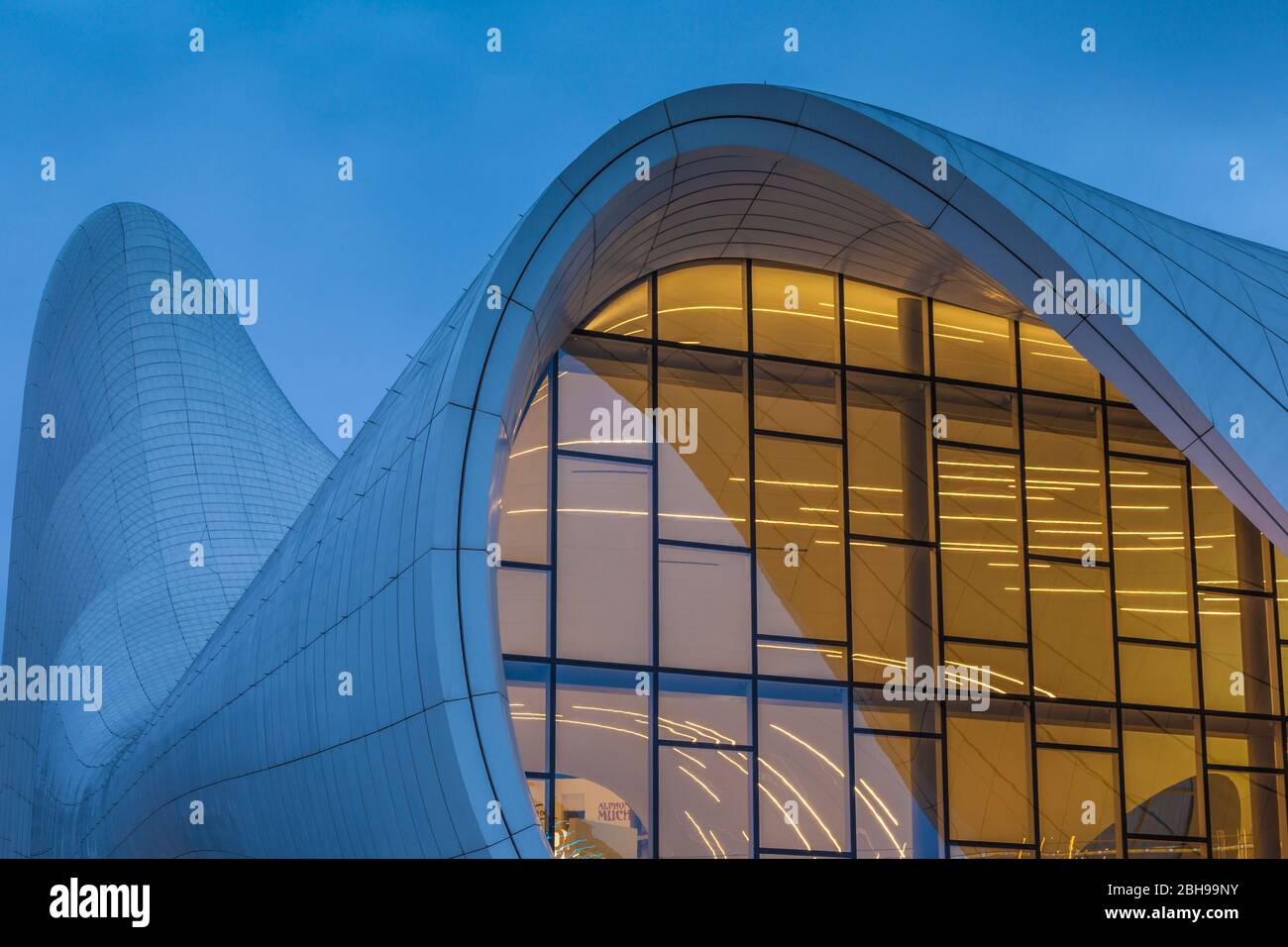 Azerbaijan, Baku, Heydar Aliyev Cultural Center, building designed by Zaha Hadid, exterior, dusk Stock Photo