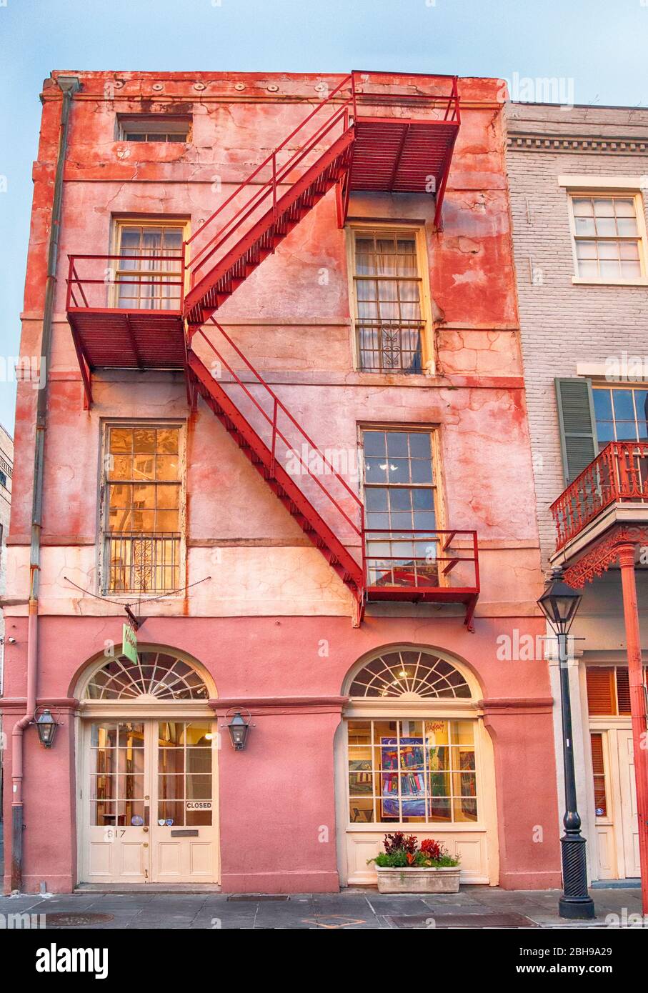 Colourfull building with external fire escape at sunrise in the French Quarter of New Orleans- composite image Stock Photo