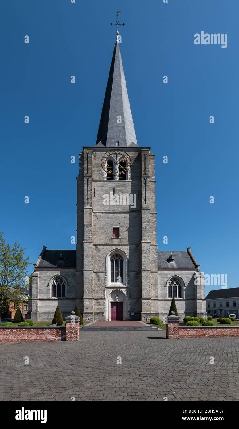 Clock tower of a Gothic parish church of St. Lambertus located on the church square in Heist-op-den-Berg on top of the mountain. Stock Photo