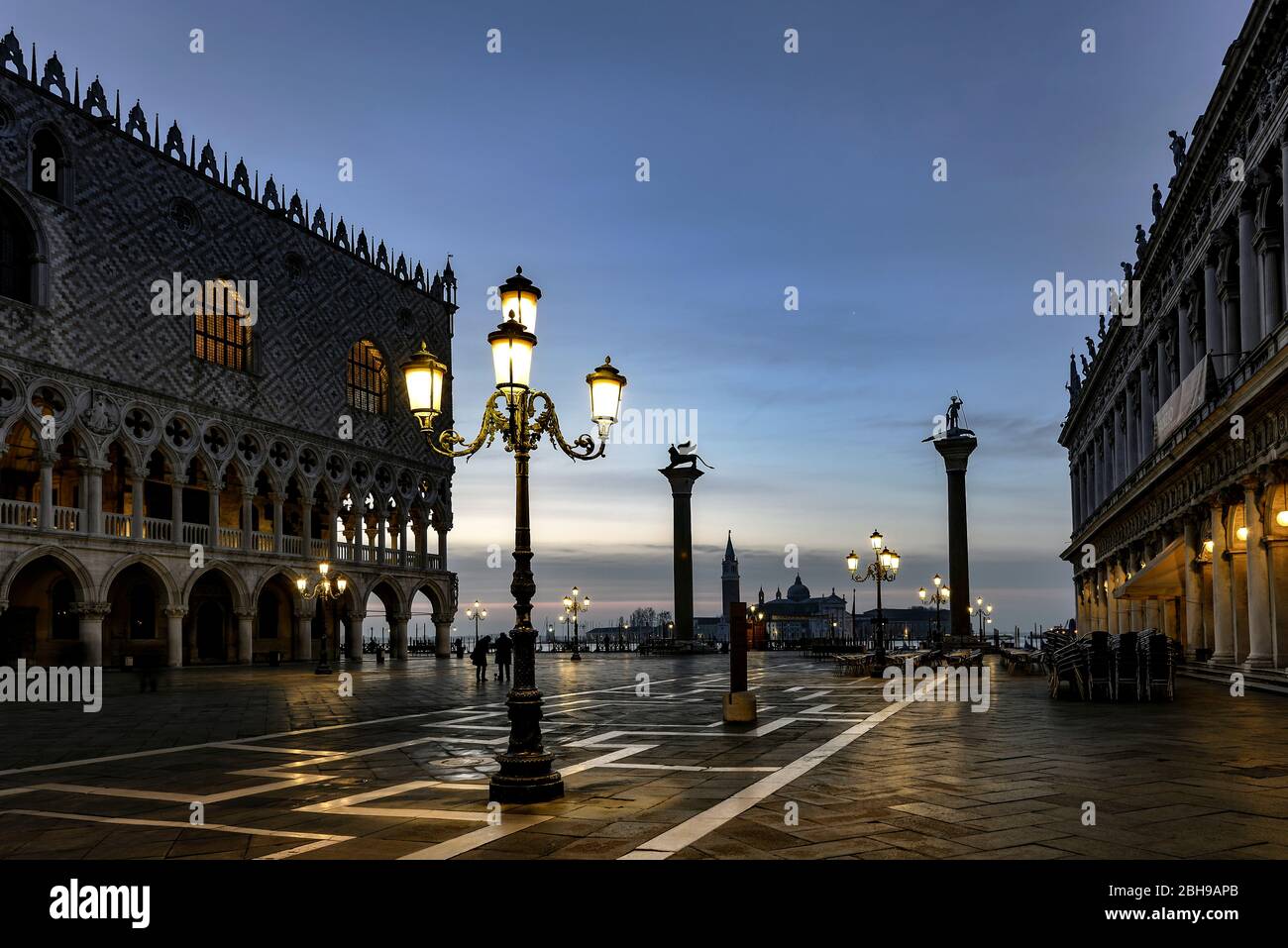 Morning mood on St. Mark's Square with Doge's Palace on a wet, cool day before sunrise in winter in Venice Stock Photo