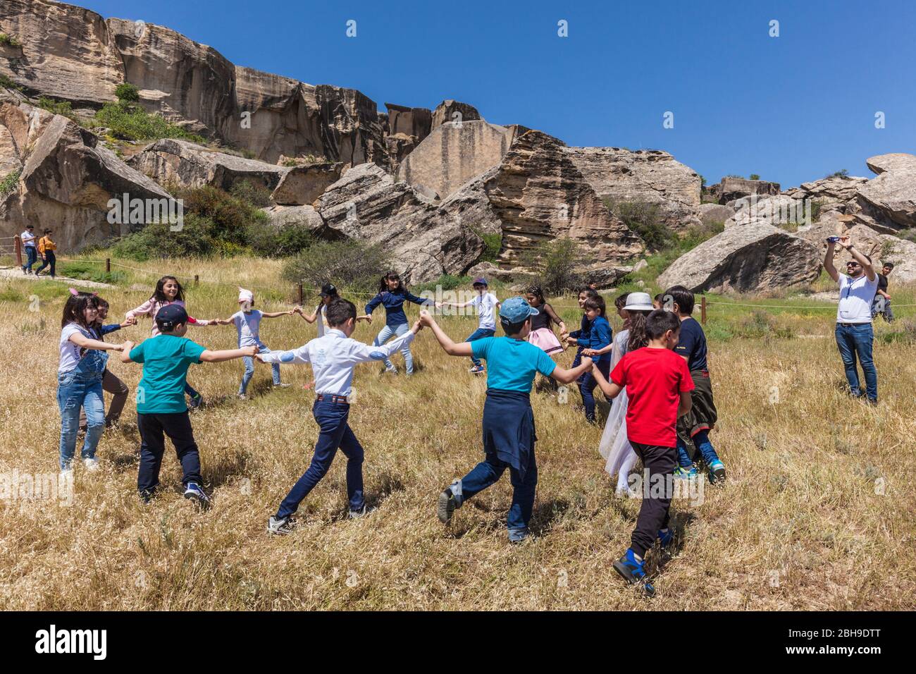 Azerbaijan, Qobustan, Qobustan Petroglyph Reserve, Petroglyph Trail, children dancing traditional dance, no releases Stock Photo