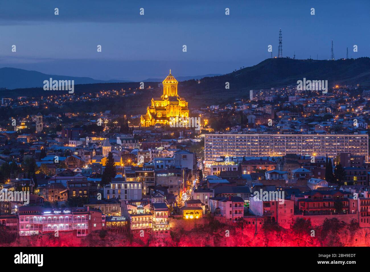 Georgia, Tbilisi, high angle view of Tsminda Sameba Cathedral, dusk Stock Photo