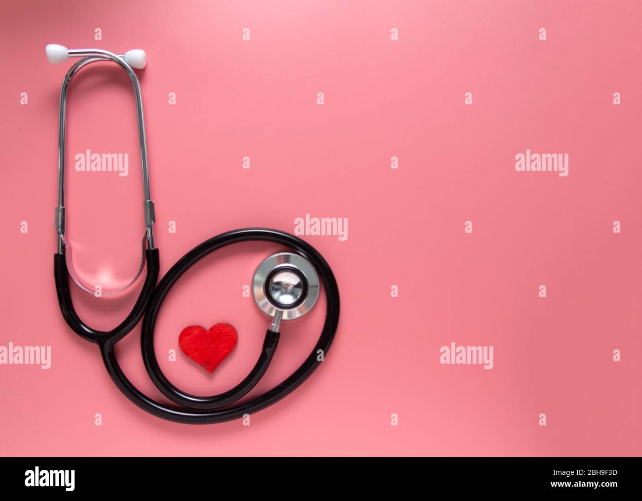 International's nurse day, week concept, stethoscope and red heart on pink background with copy space. Space for text. Stock Photo