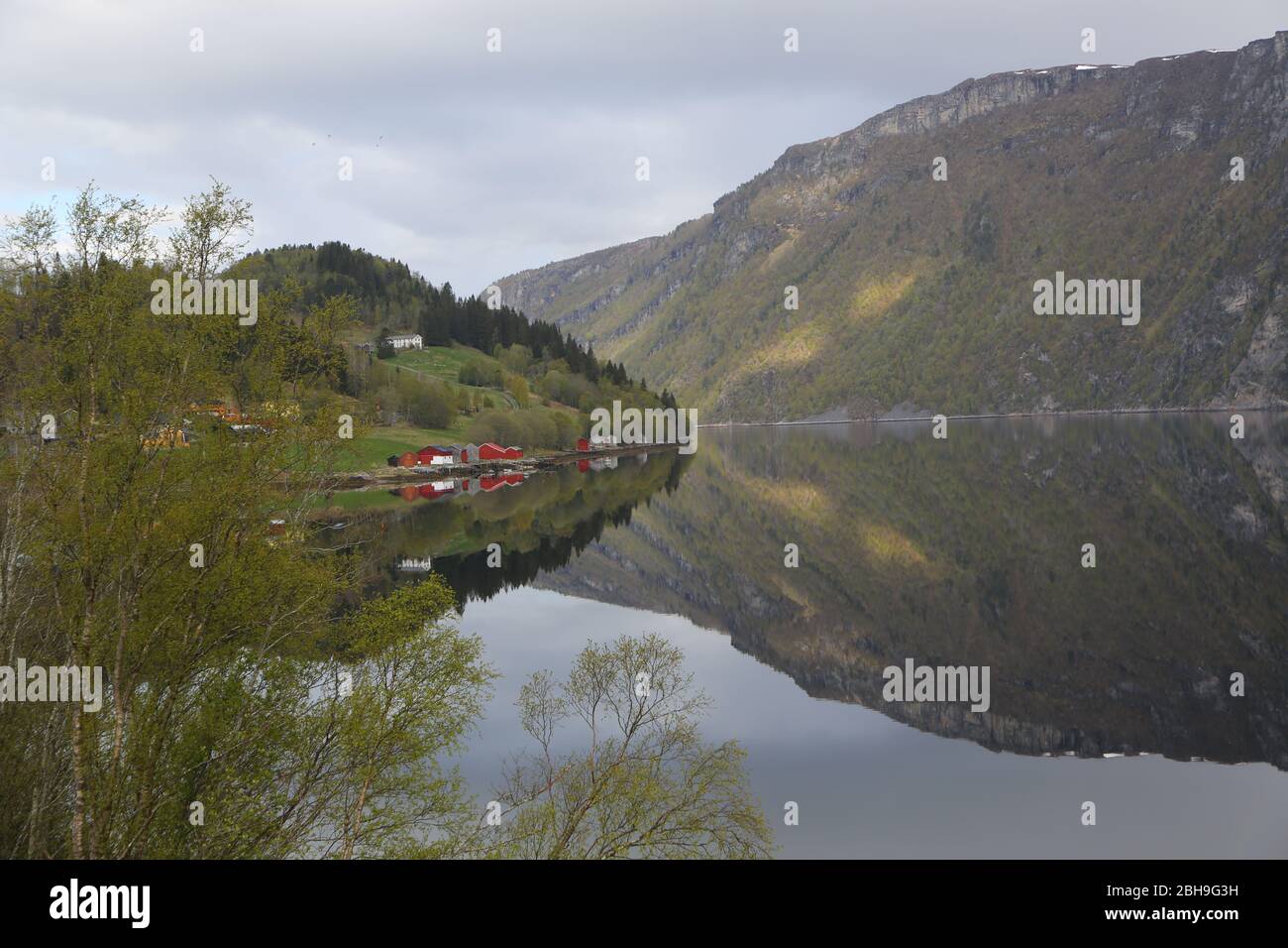 Village reflected perfectly in water Stock Photo