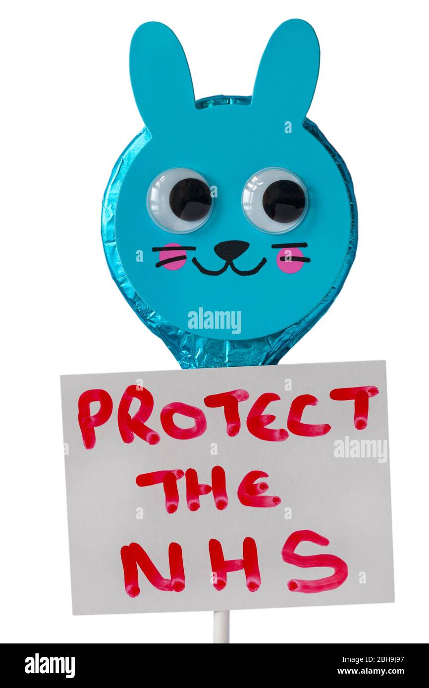 M&S Easter Bunny foiled solid milk chocolate lollipop with Protect the NHS sign on white background - concept to stay home for Coronavirus lockdown UK Stock Photo