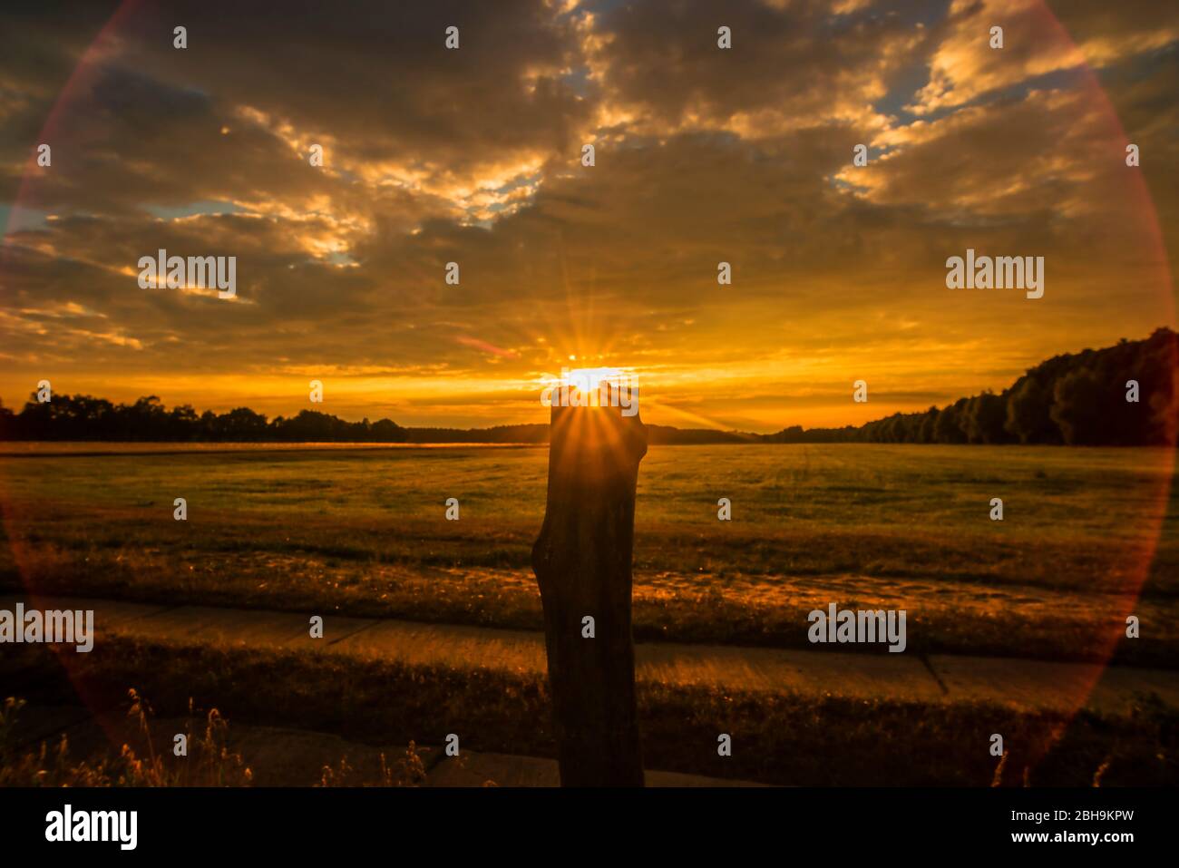 Sunset over agricultural land Stock Photo