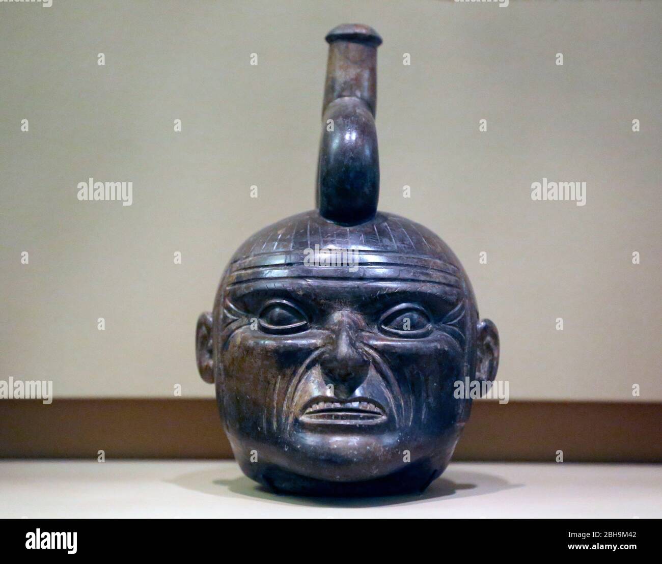 Pre-Columbian era. Moche style. Ceramic molded in form of a head with grimacing face. Peru. Early Intermediate (200AD-600AD). Stock Photo