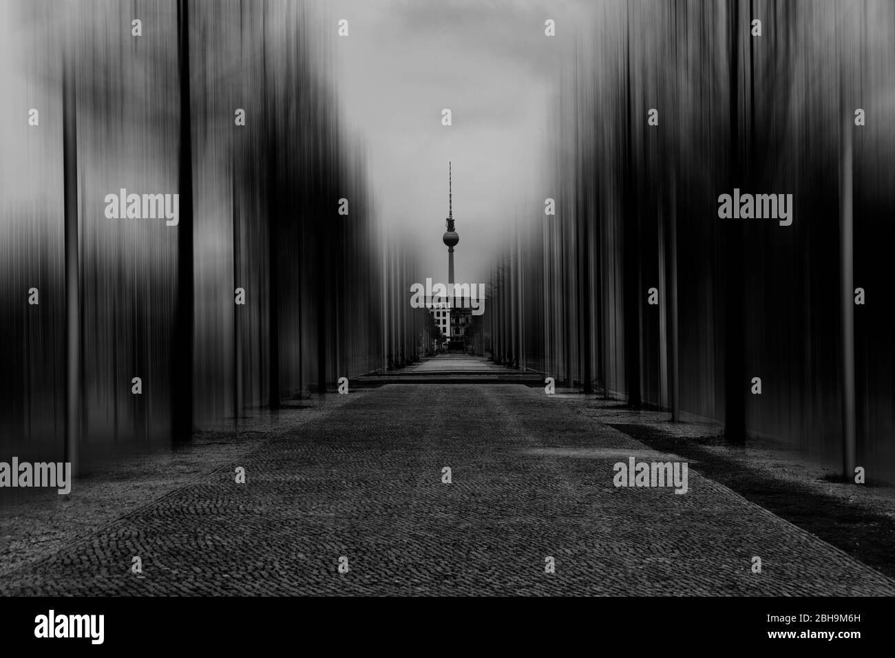 Pedestrian walkway in Berlin with a view to the television tower and close to Surreal edited of trees Stock Photo