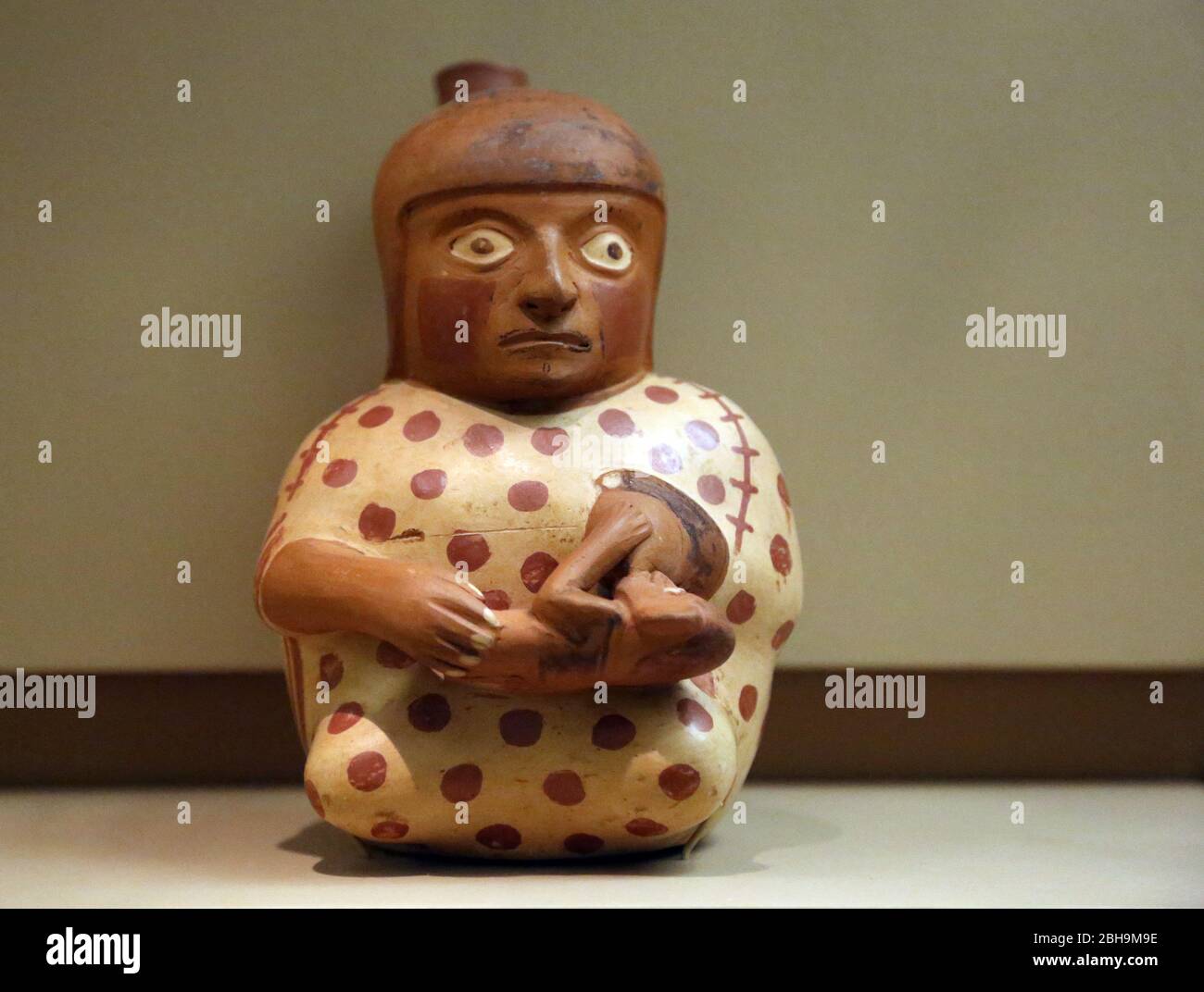Pre-Columbian era. Ceramic molded in form of a nursing woman. Moche style. Early Intermediate (200A-600AD). Peru. Stock Photo