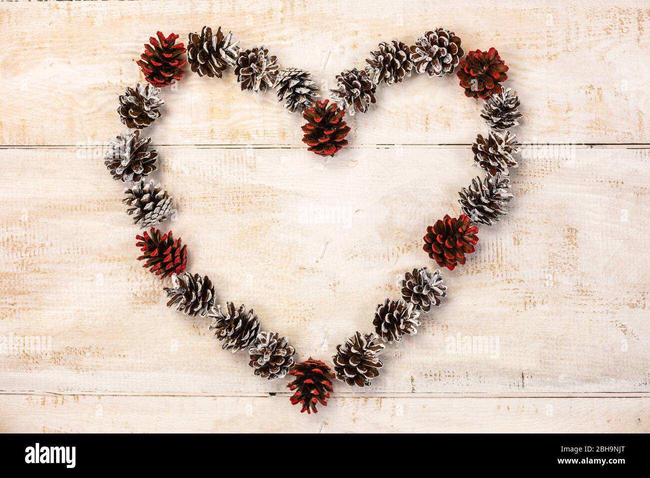 Heart from cones on wooden background Stock Photo - Alamy
