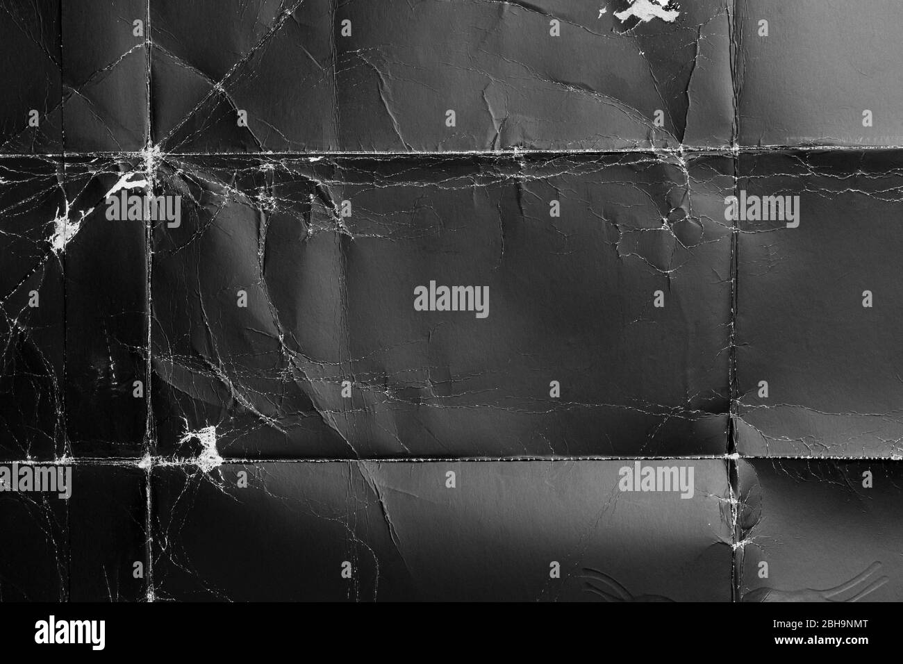 Crumpled black paper with wrinkles and rubbed corners. Old wrapping ...