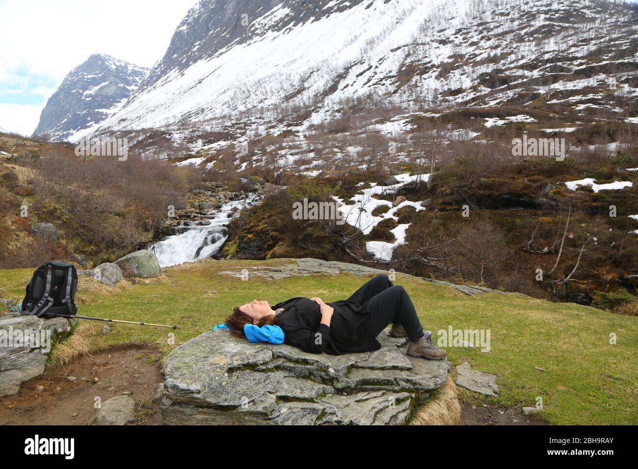Woman resting after climbing hills in Norway Stock Photo