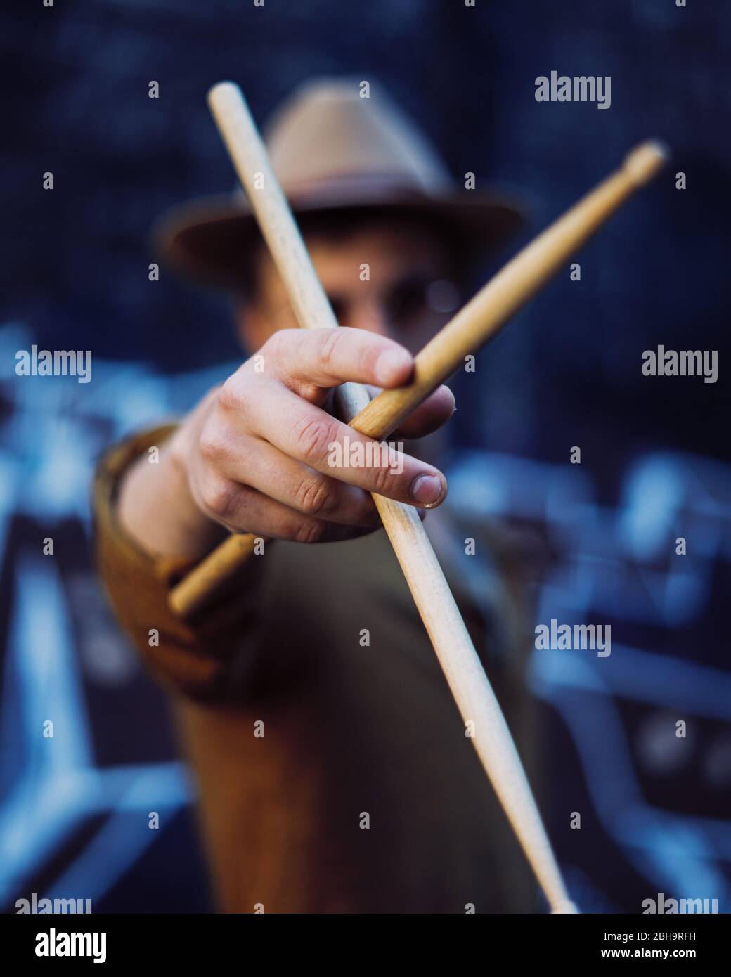 Young man playing drums in an underground environment Stock Photo