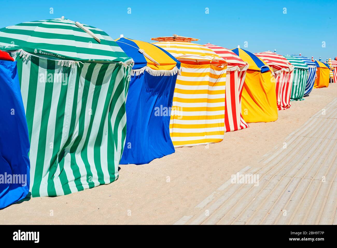 Traditional beach umbrellas in Trouville, Normandy France Stock Photo
