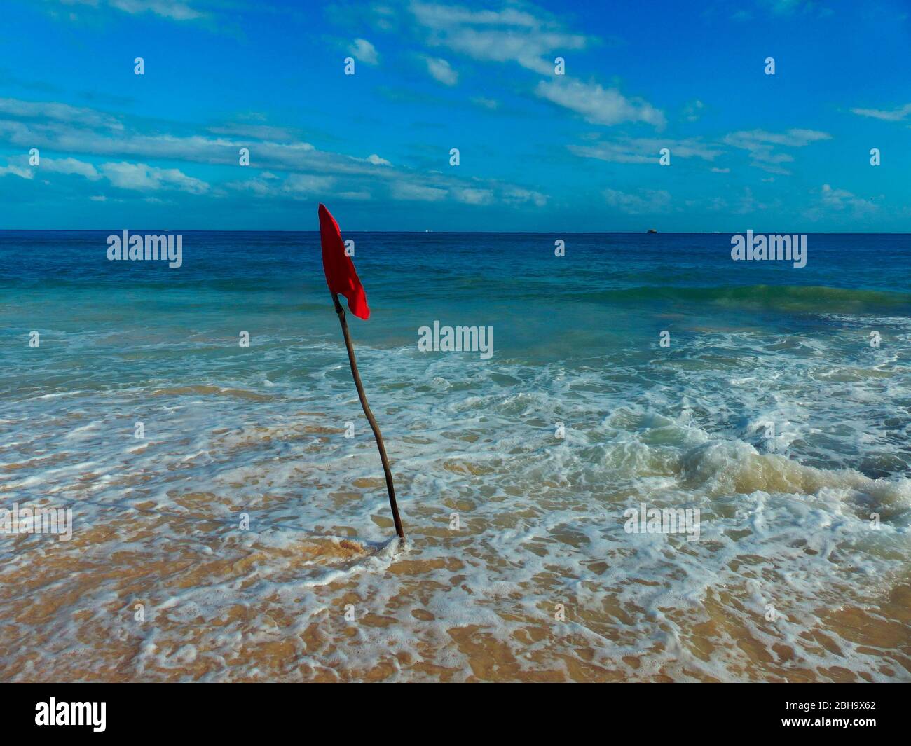 Red flag, placed by life guard, indicates danger. No swimmers should enter the water. Stock Photo