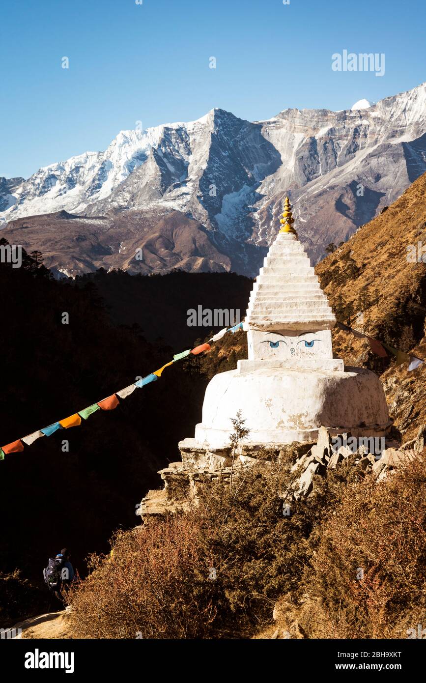 Temple with prayer flag, mountains in the background Stock Photo