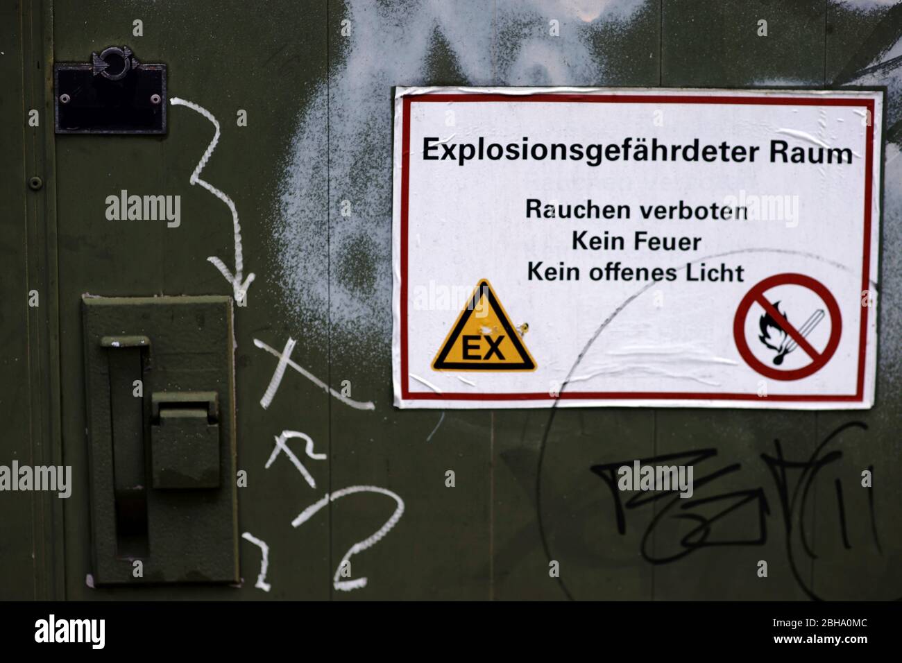 A chemical tank with lockable and secured door as well as a warning label: Caution: explosive area. Stock Photo