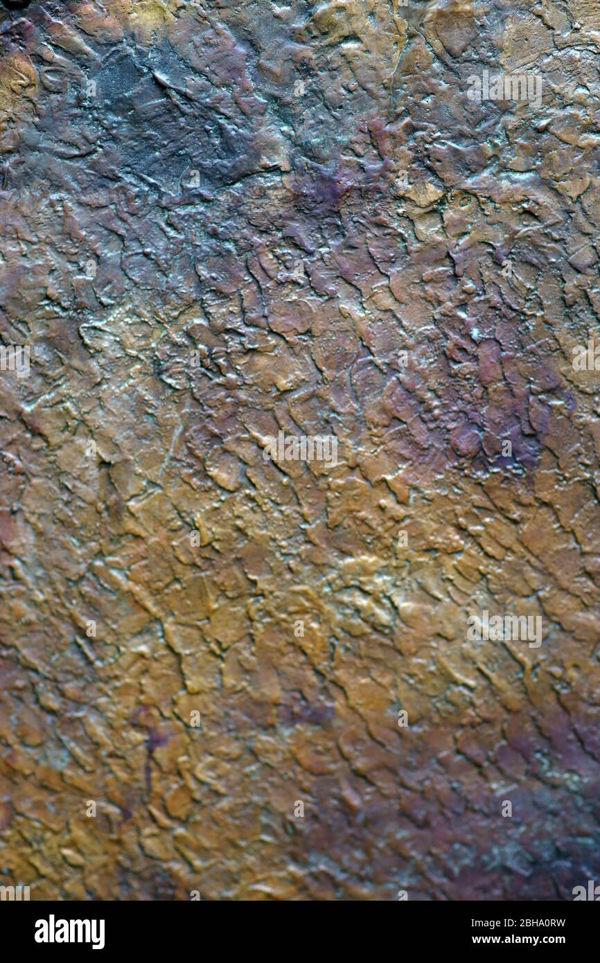 The close-up of a rusty and colorful metal surface with texture and texture. Stock Photo