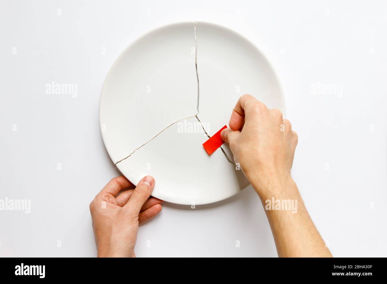 Top View Of Man Hands Holding A Broken White Plate Glues Parts With Red Tape Metaphor For Divorce Relationships Friendships Crack In Marriage Is Stock Photo Alamy Top View Of Man Hands Holding A Broken White Plate Glues Parts With Red Tape Metaphor For Divorce Relationships Friendships Crack In Marriage Is Stock Photo Alamy