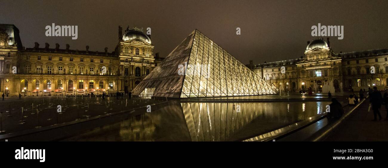 Illuminated Louvre Museum at night, Paris, France Stock Photo
